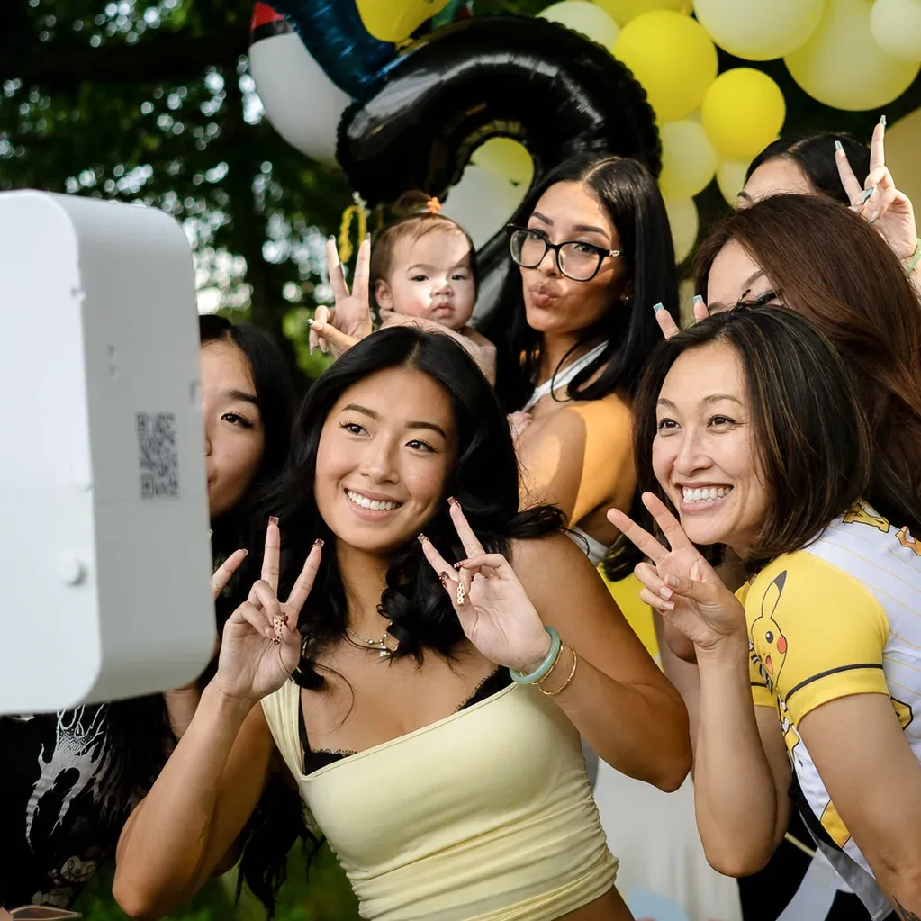 Friends throwing peace signs at a backyard party