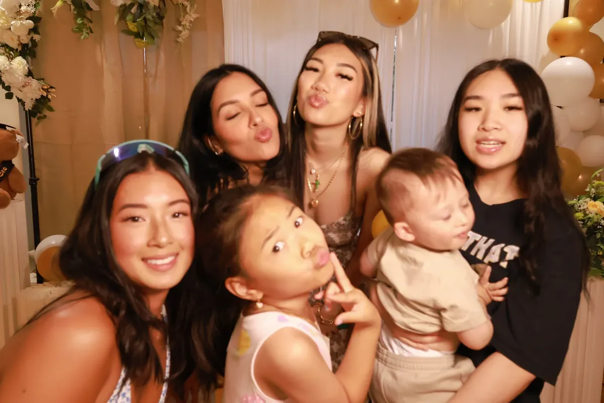 Family making silly faces at the booth